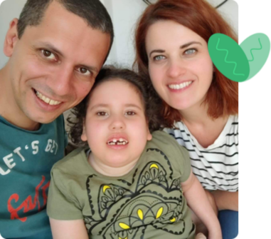 Family smiling with a child with ECHS1 Deficiency